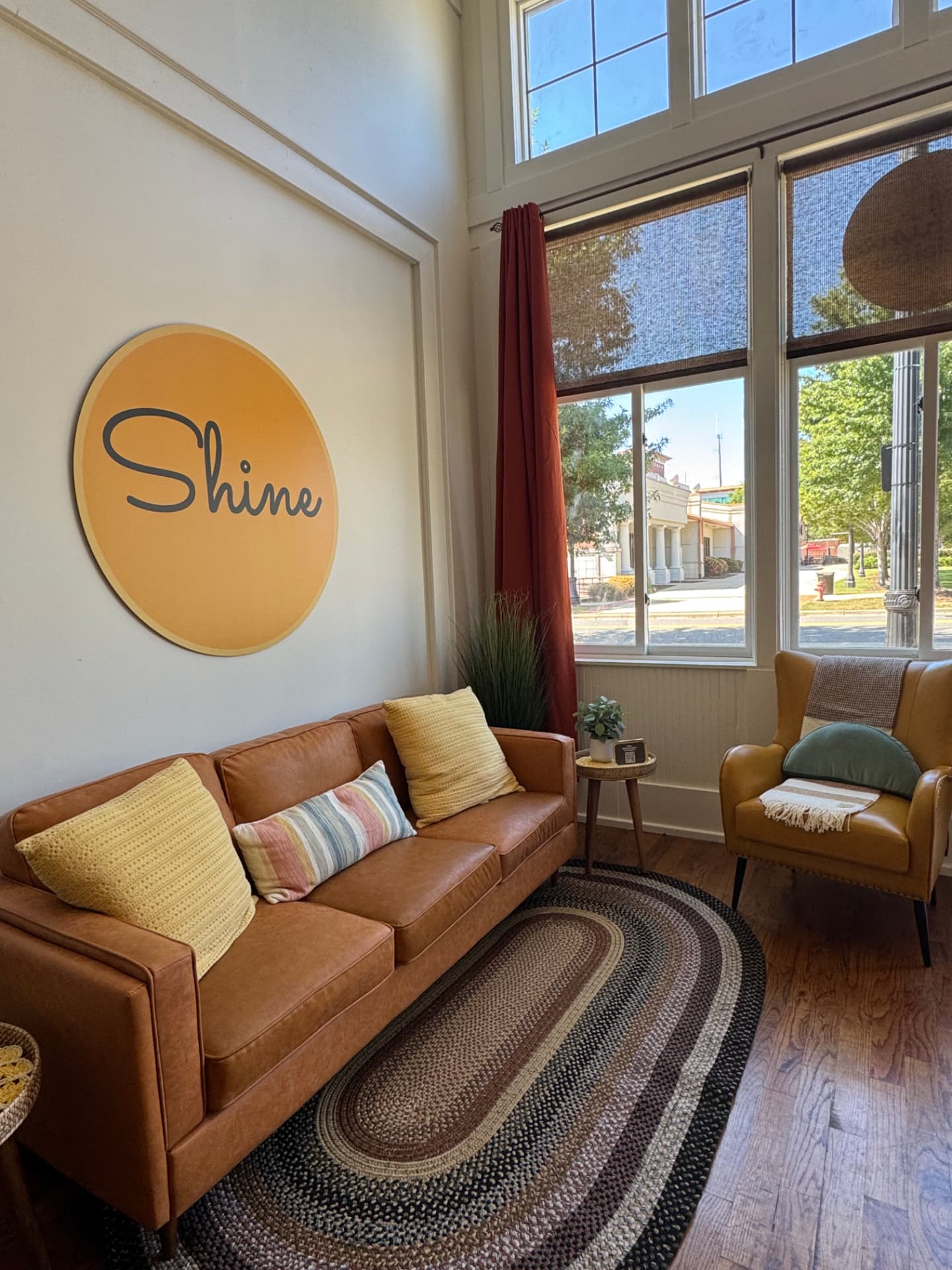 Shine Facial Bar Downtown waiting room with a leather sofa and the yellow Shine sign